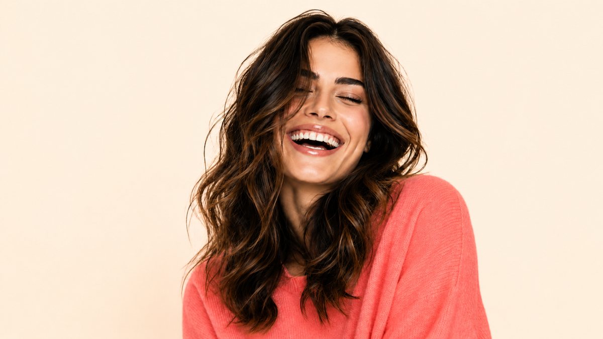 A woman laughing with a bright, healthy smile